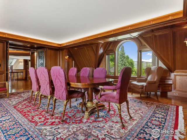 a dining room with furniture and wooden floor