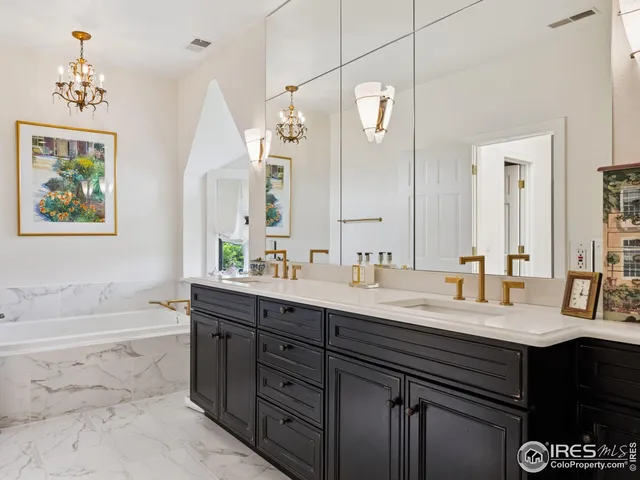 a bathroom with a tub sink and mirror