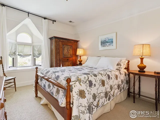 a bedroom with a bed and a mirror