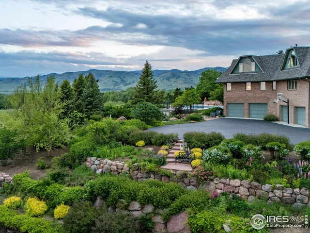 an aerial view of a house with garden space and street view