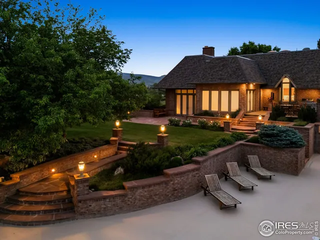 a view of a house with backyard and sitting area
