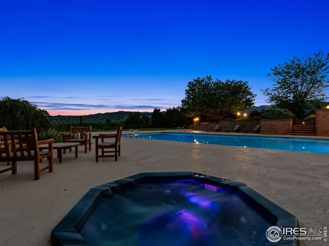 a view of swimming pool with outdoor seating and yard in back