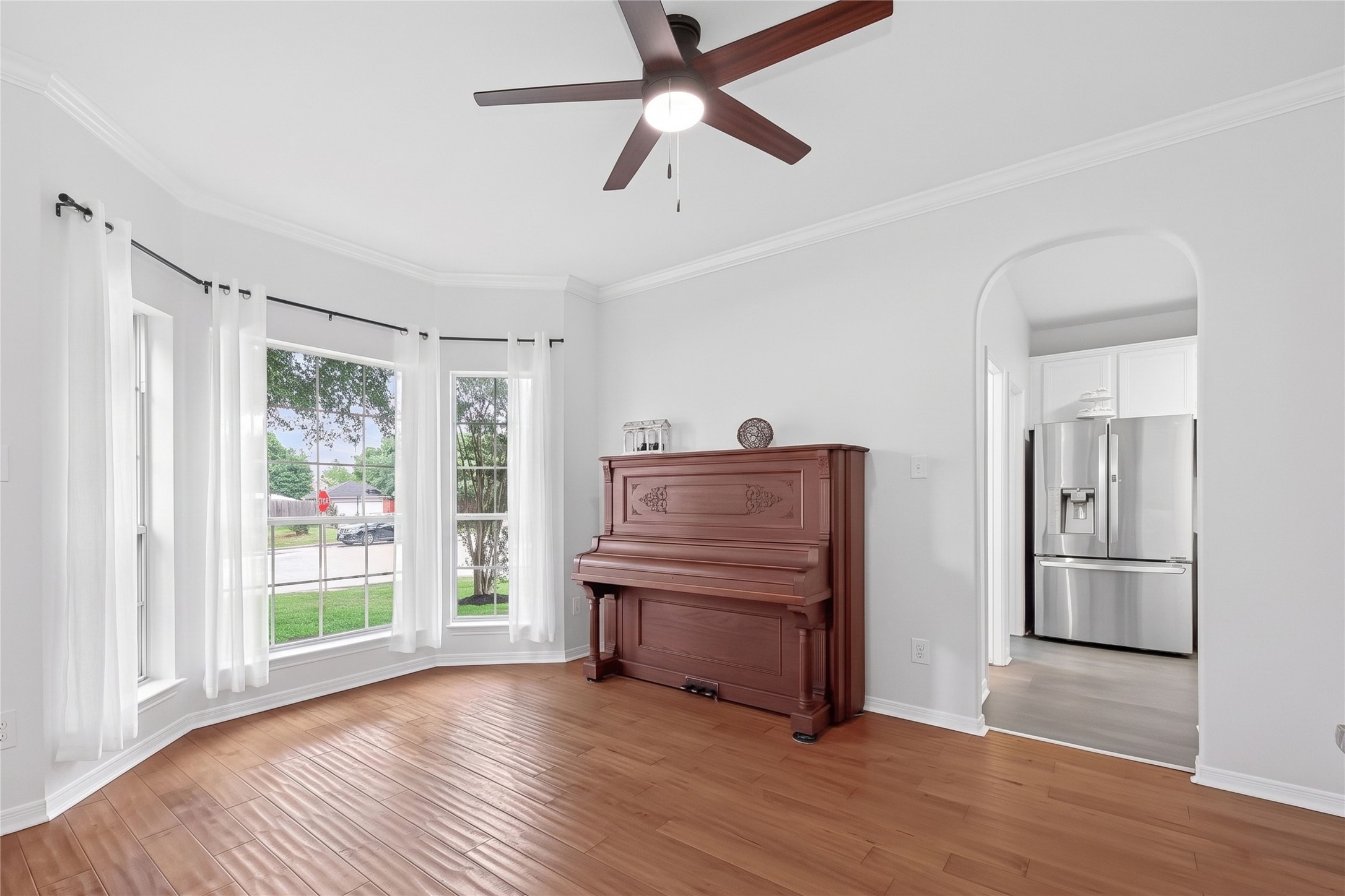 7411 Stonesfield Place Spring, TX 77389 - Photo 7 of 44 Formal dining room with beautiful wood flooring, crown molding, entry to kitchen, living room, lots of windows for natural lighting. This room is separated from the living room, yet still connected.