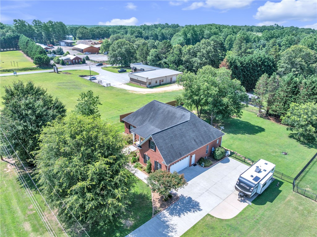 648 Mountain View Road Williamston, SC 29697 - Photo 38 of 42 An aerial perspective reveals the property's generous land and brick exterior, offering an integrated garage and a long, curving driveway.