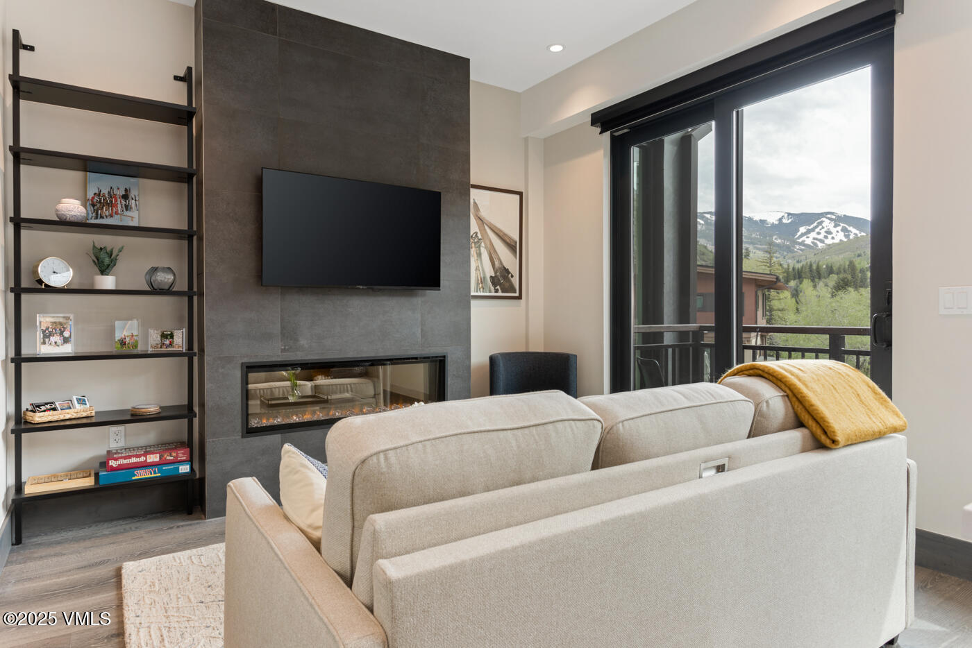 a living room with furniture a flat screen tv and a fireplace