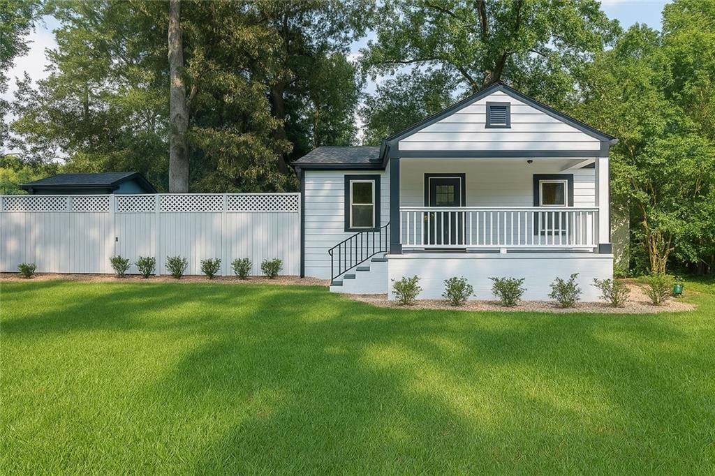 a front view of a house with a yard and porch