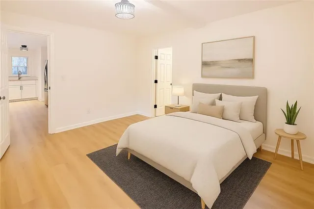 a bedroom with a bed and a night stand