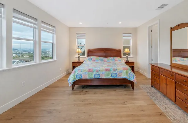 a bedroom with a large bed and a window