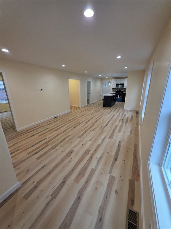 a view of empty room with a fireplace