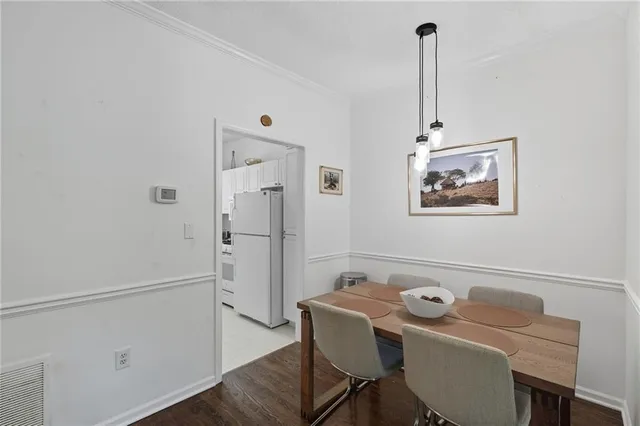 a view of a room that has a bed and a table in it