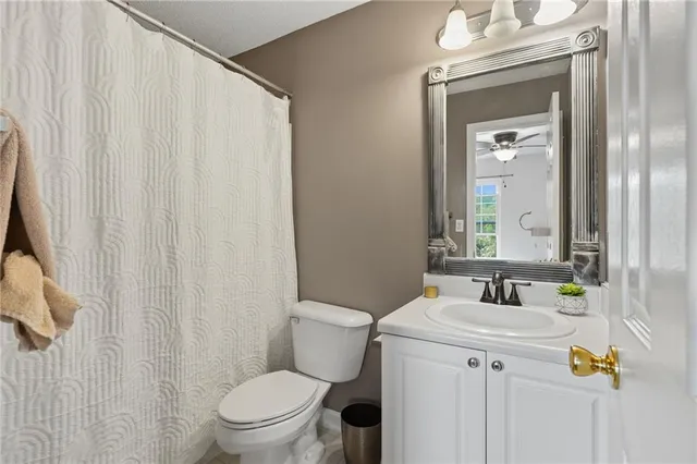 a bathroom with a sink vanity mirror and toilet