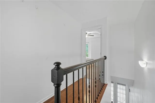 a view of a hallway with wooden floor