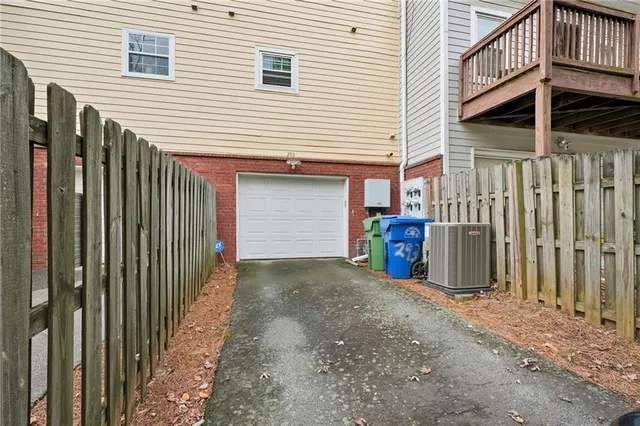 a view of a house with a garage and wooden fence