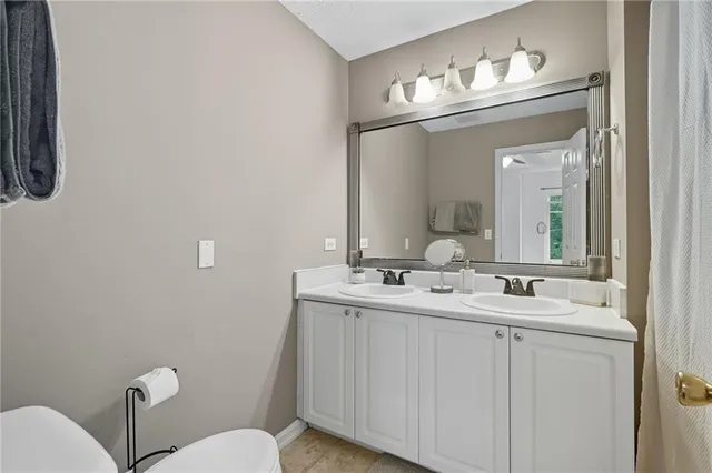 a bathroom with a toilet sink and mirror