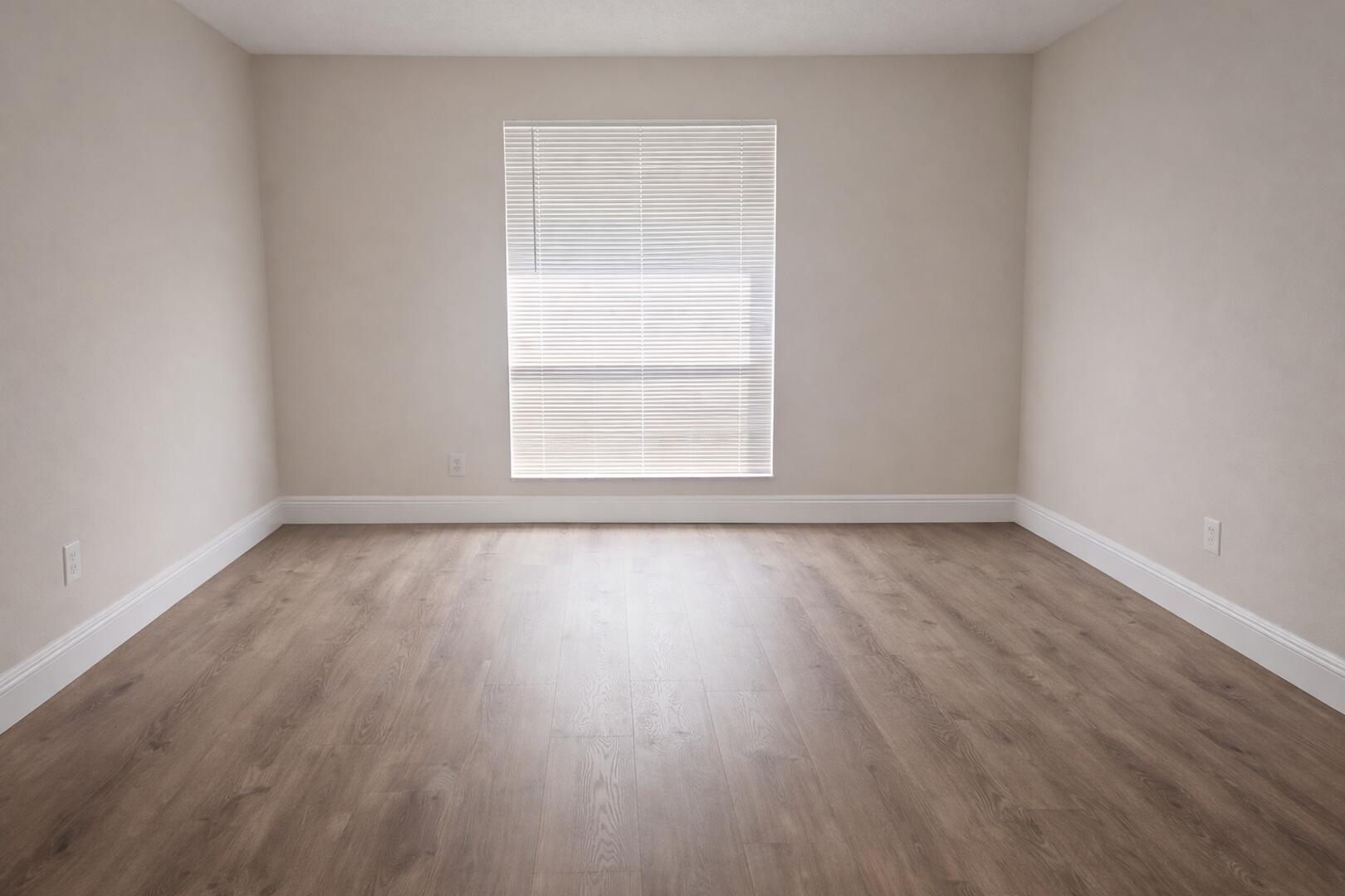 541 Northeast 48th Street, Unit 205 Boca Raton, FL 33431 - Photo 3 of 8 an empty room with wooden floor and windows