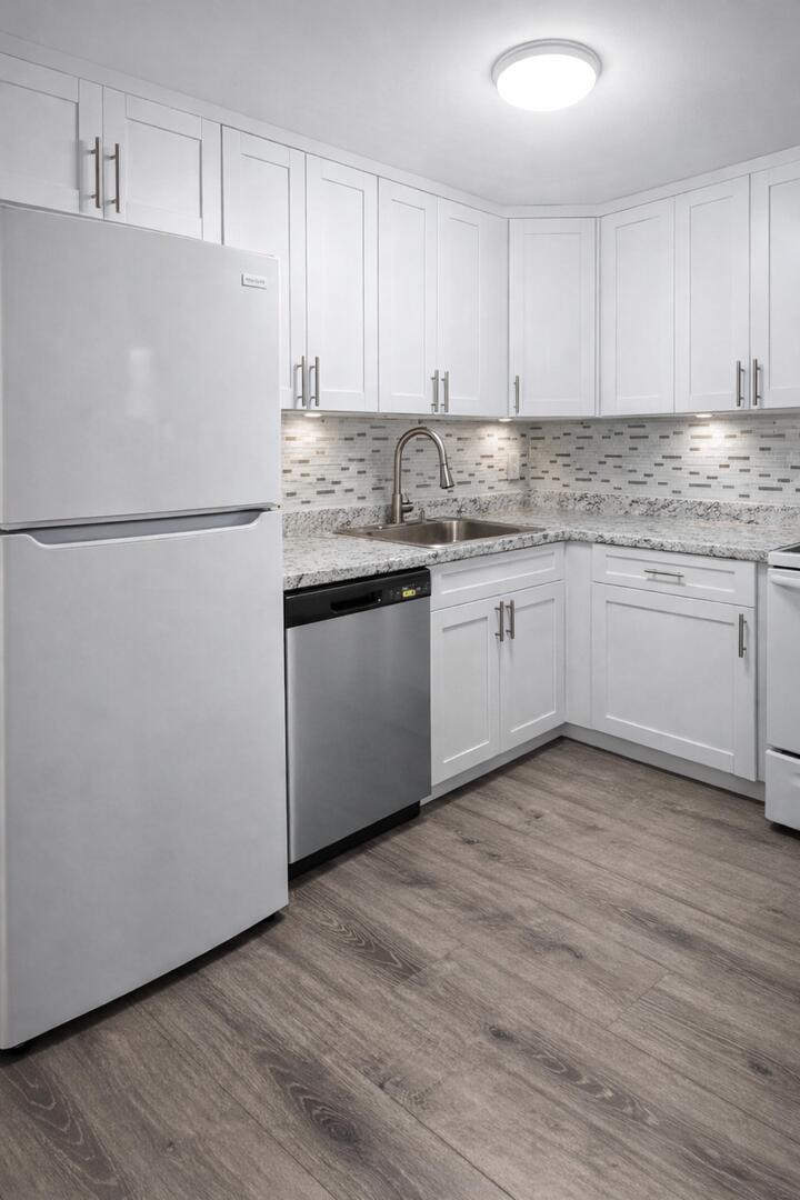 541 Northeast 48th Street, Unit 205 Boca Raton, FL 33431 - Photo 6 of 8 a white refrigerator freezer sitting inside of a kitchen