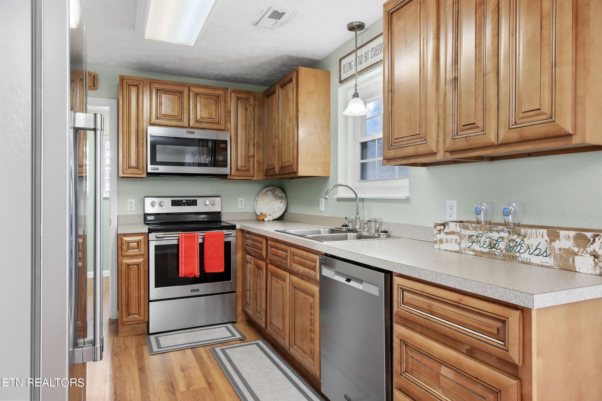 2252 Shinbone Road Sevierville, TN 37876 - Photo 11 of 27 a kitchen with stainless steel appliances a stove sink microwave and cabinets