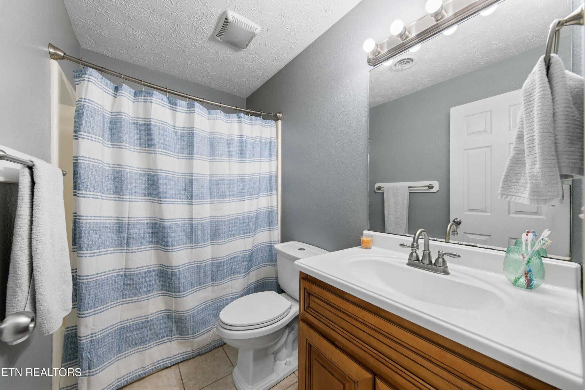 2252 Shinbone Road Sevierville, TN 37876 - Photo 15 of 27 a bathroom with a sink a toilet a shower and a mirror