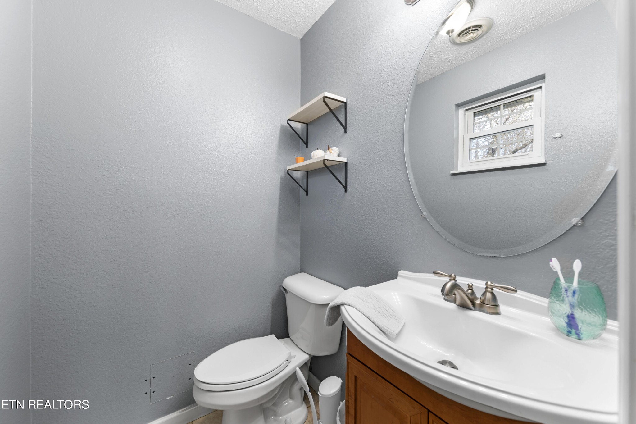 2252 Shinbone Road Sevierville, TN 37876 - Photo 19 of 27 a bathroom with a sink a toilet and mirror