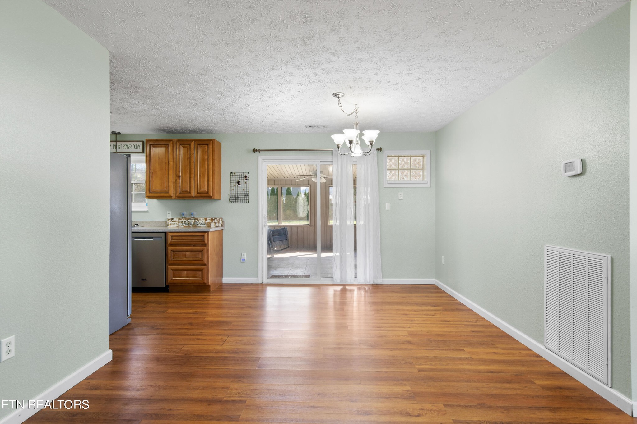 2252 Shinbone Road Sevierville, TN 37876 - Photo 5 of 27 a view of a kitchen with a sink a refrigerator and wooden floor