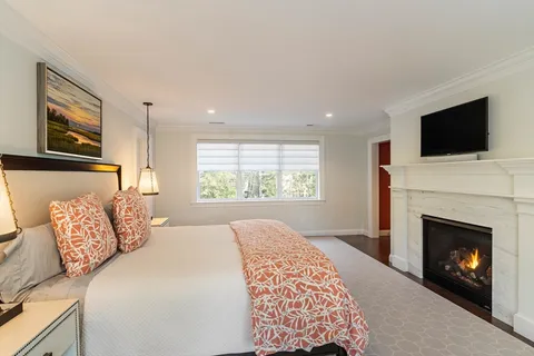 a bedroom with a bed and a fireplace