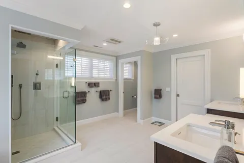a bathroom with a shower sink and mirror