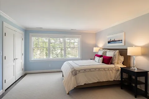 a bedroom with a bed and window