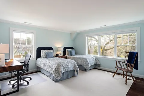 a spacious bedroom with two beds and a table