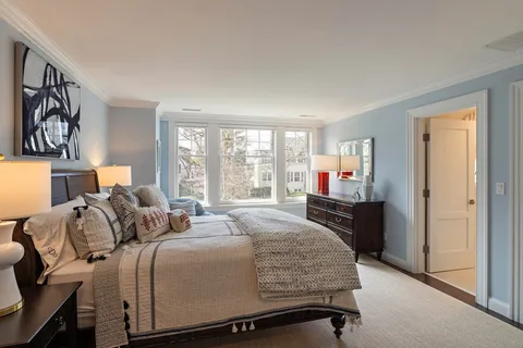 a bedroom with a large bed and a large window