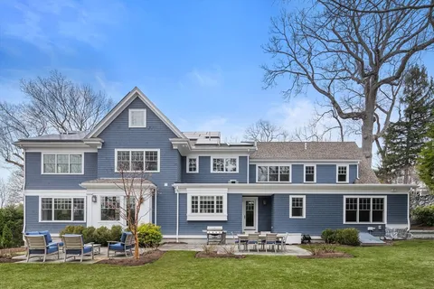 a front view of a house with yard and green space
