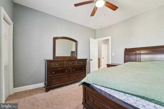 a bedroom with a bed and a dresser