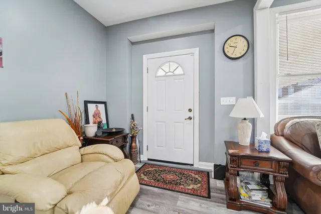 a bedroom with a bed and a lamp on dresser