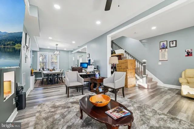 a living room with furniture and wooden floor