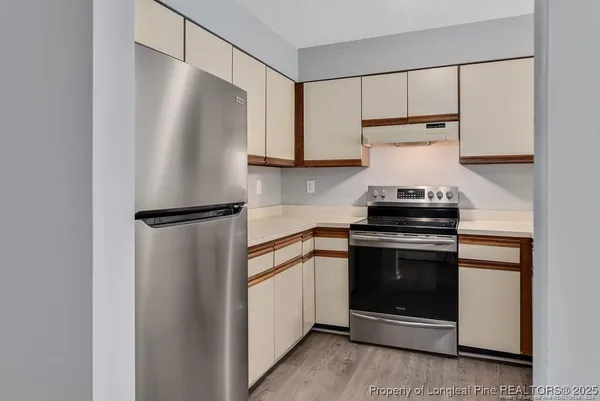 a kitchen with cabinets and appliances