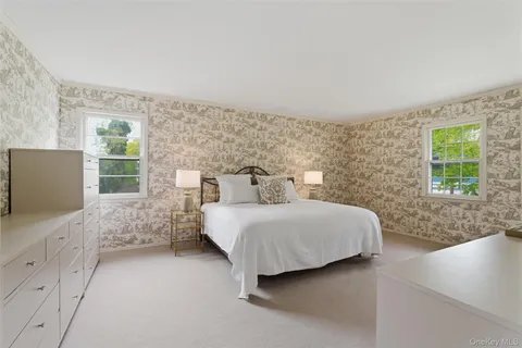 a spacious bedroom with a bed and a window