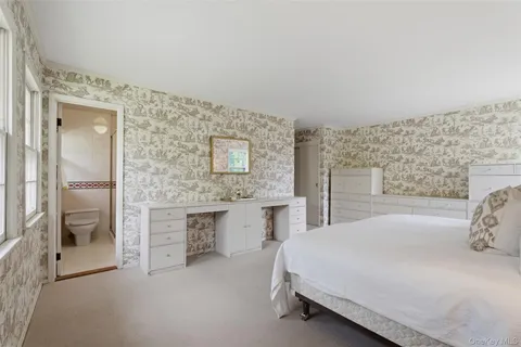 a bedroom with a bed and a table