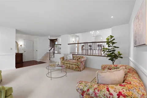 a living room with furniture and flowers