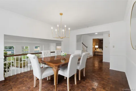 a dining room with furniture and chandelier