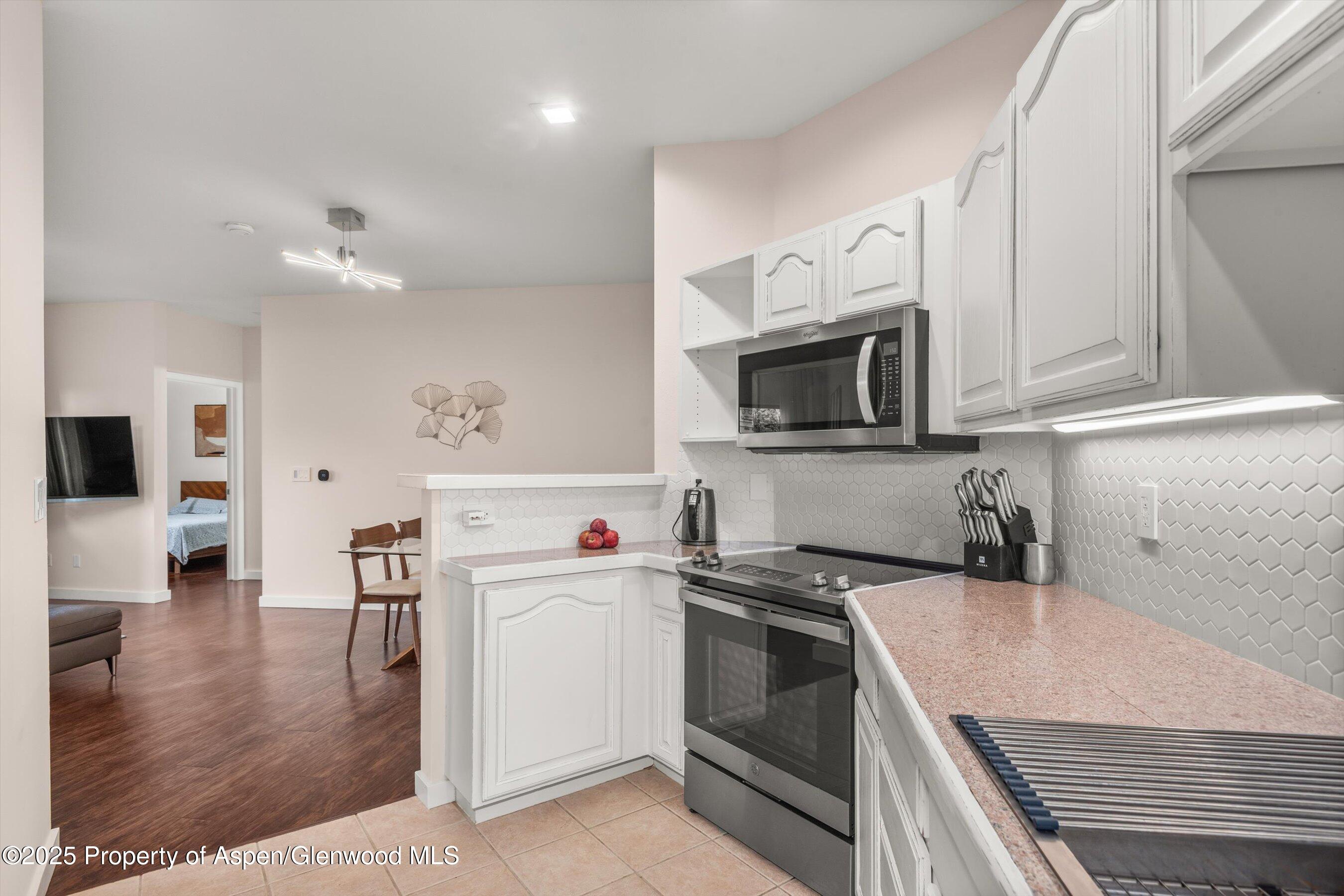 1400 East Valley Road, Unit 115 Basalt, CO 81621 - Photo 11 of 17 a kitchen with a sink a stove and cabinets