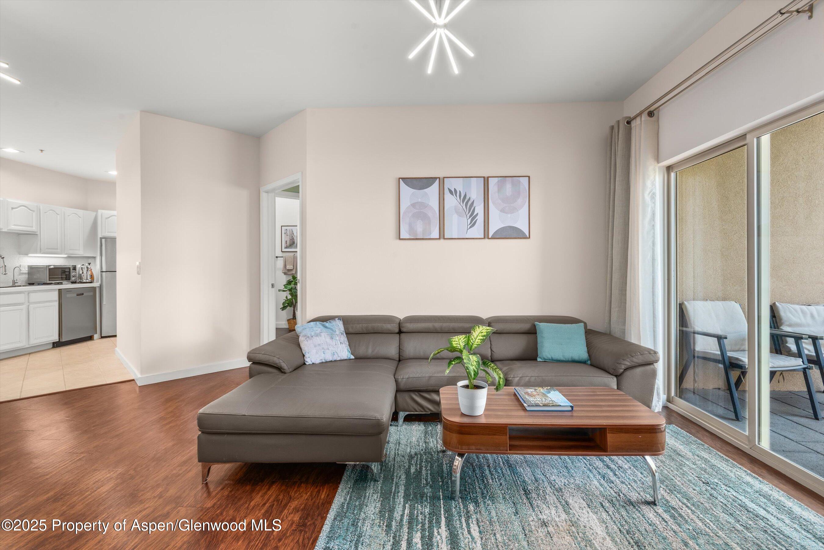 1400 East Valley Road, Unit 115 Basalt, CO 81621 - Photo 3 of 17 a living room with furniture and a wooden floor