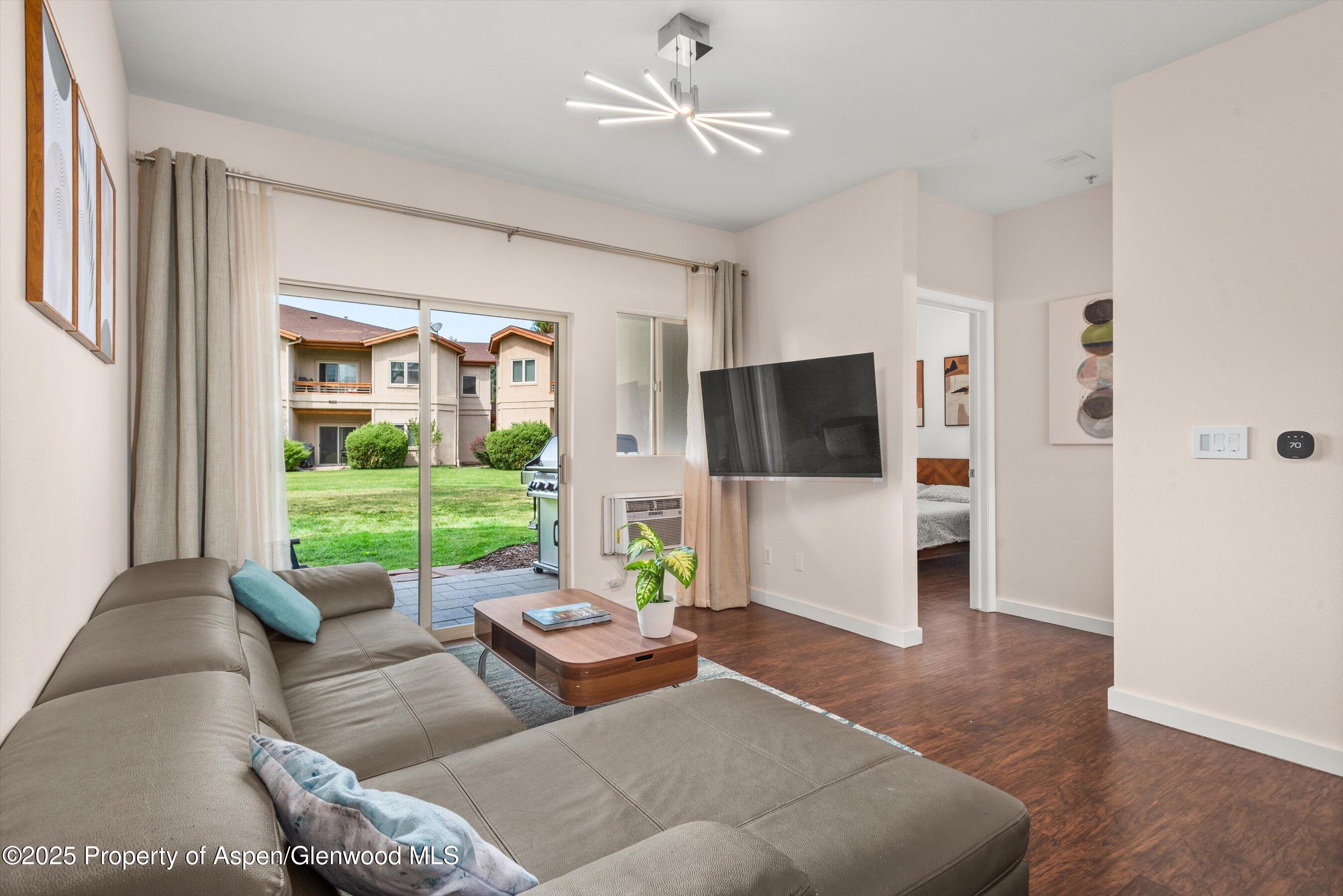 1400 East Valley Road, Unit 115 Basalt, CO 81621 - Photo 5 of 17 a living room with furniture and a flat screen tv