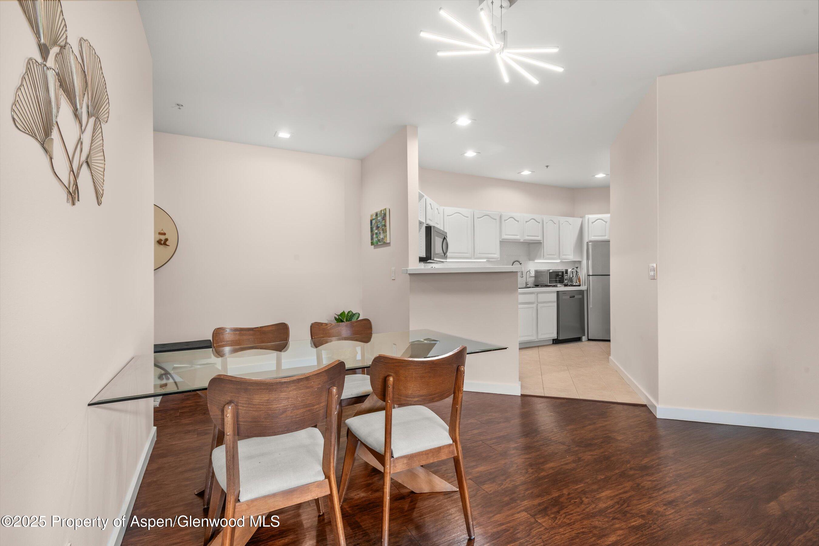 1400 East Valley Road, Unit 115 Basalt, CO 81621 - Photo 7 of 17 a view of a dining room with furniture and wooden floor