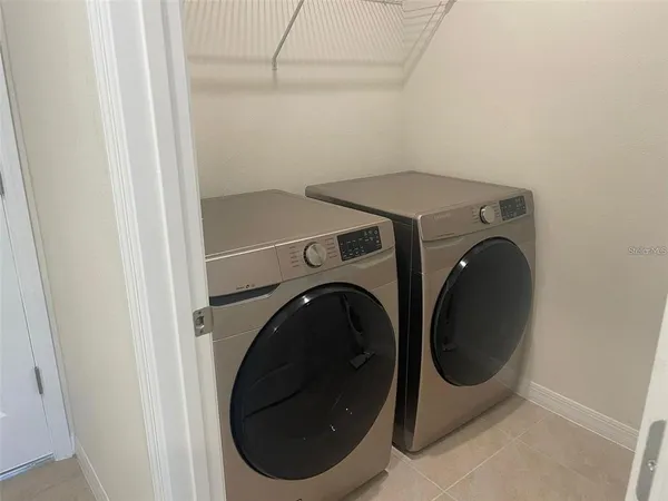 an empty room with closet and a bathroom