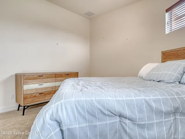 a bedroom with a bed and chair