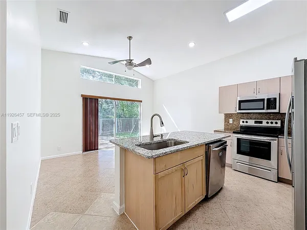 a kitchen with a sink appliances and cabinets
