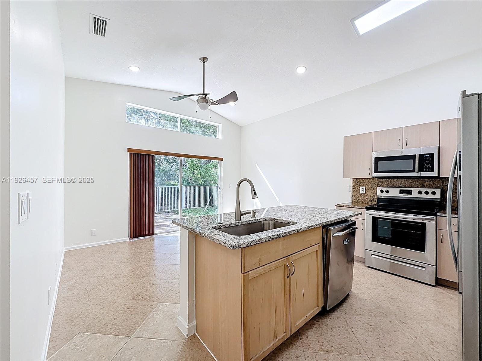 a kitchen with a sink appliances and cabinets