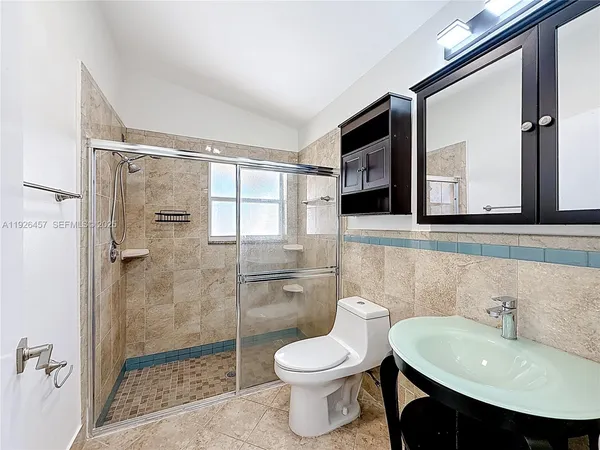 a bathroom with a sink toilet and shower
