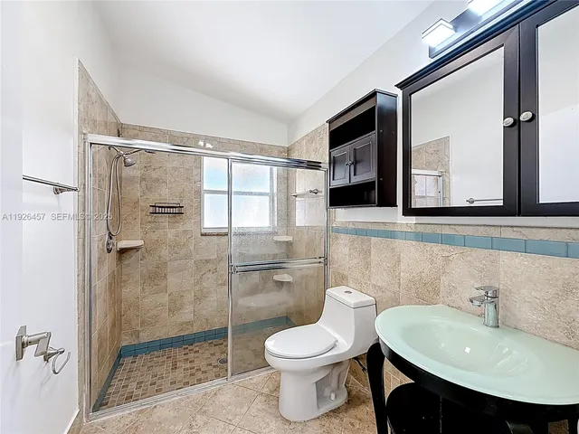 a bathroom with a sink toilet and shower