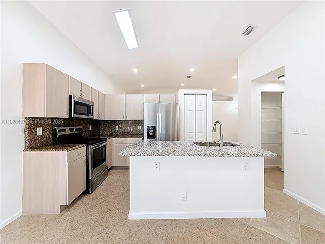 a view of kitchen with granite countertop