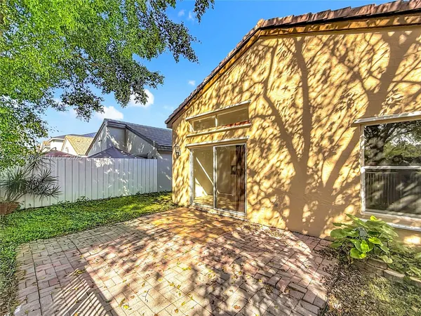 a view of a yard with wooden fence